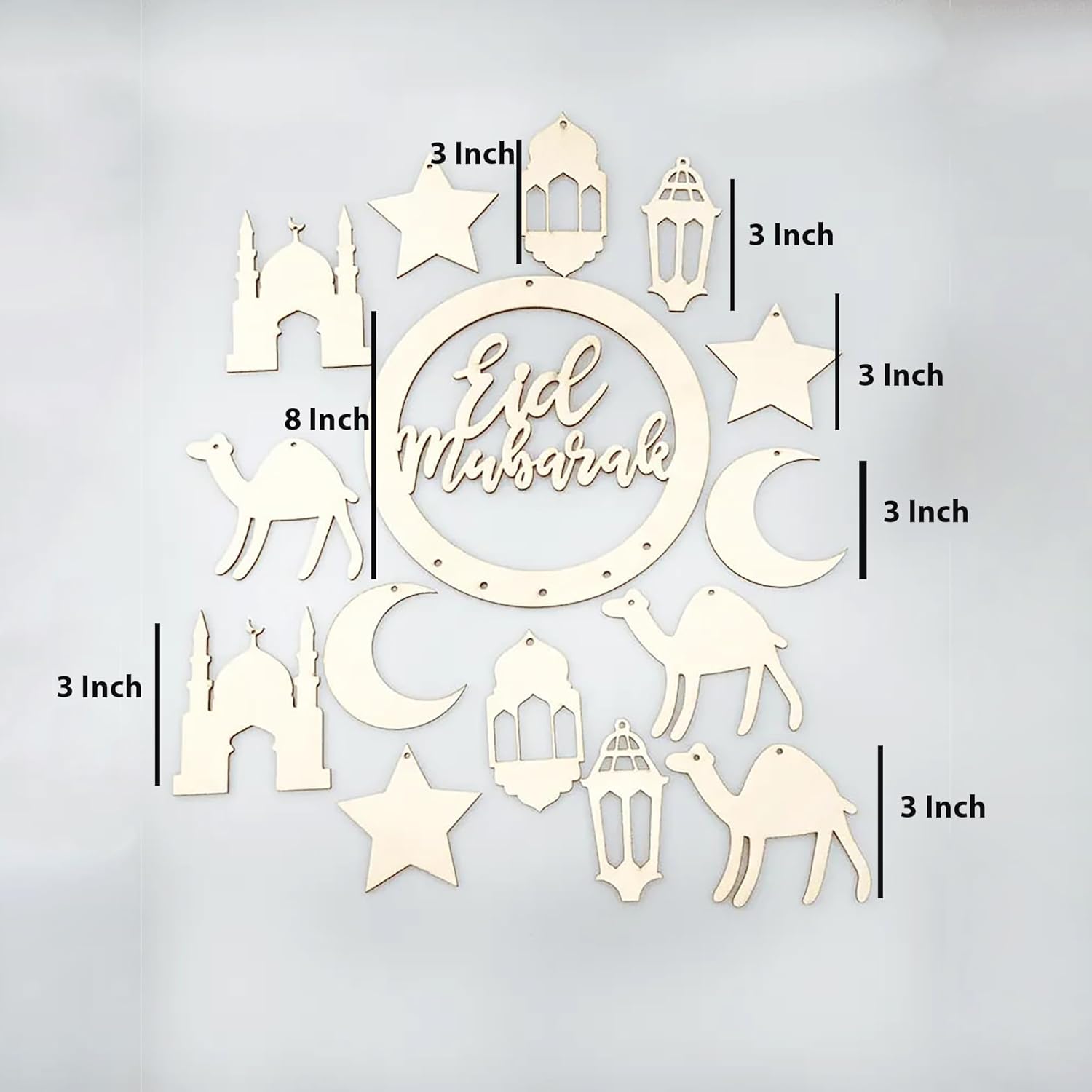 Decorative wall art with 'Eid Mubarak' text and various Islamic symbols on a light gray background.