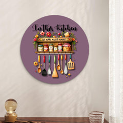 Decorative wall clock with kitchen-themed design on a plain wall.