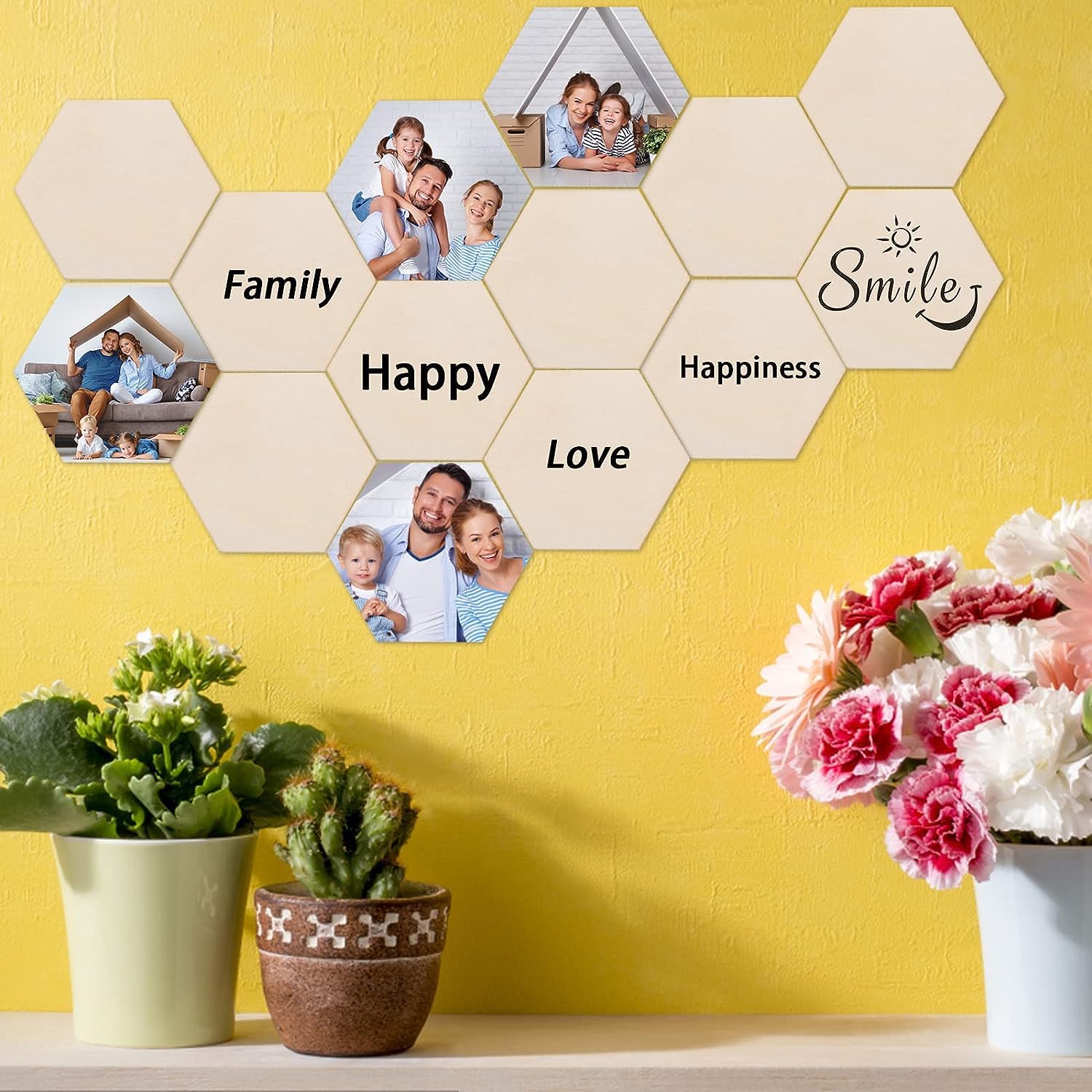 Hexagonal wall art with family photos and text on a yellow wall, with plants and flowers below.