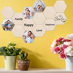 Hexagonal wall art with family photos and text on a yellow wall, with plants and flowers below.