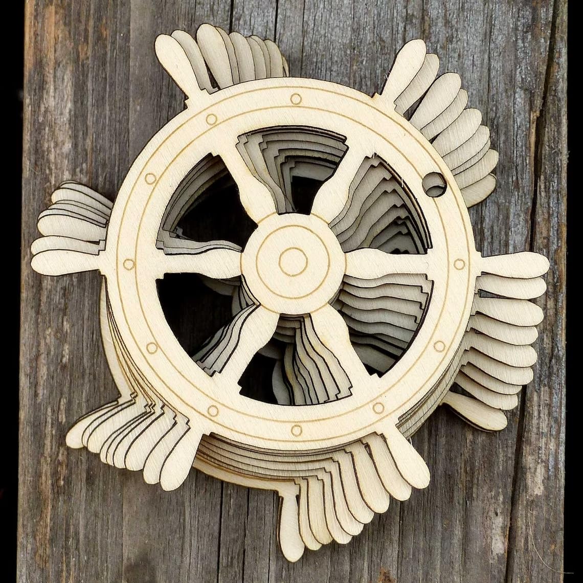 Wooden decorative propeller on a wooden background