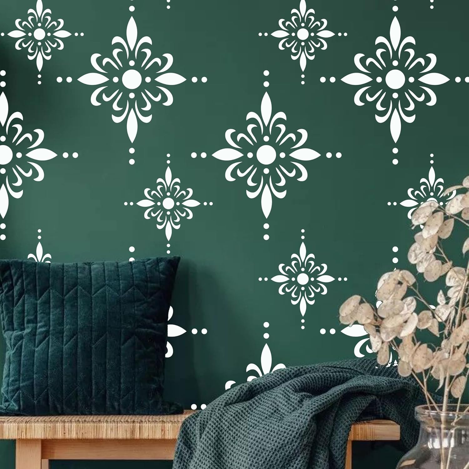 Green wall with white floral pattern, dark green cushion, and wooden bench.