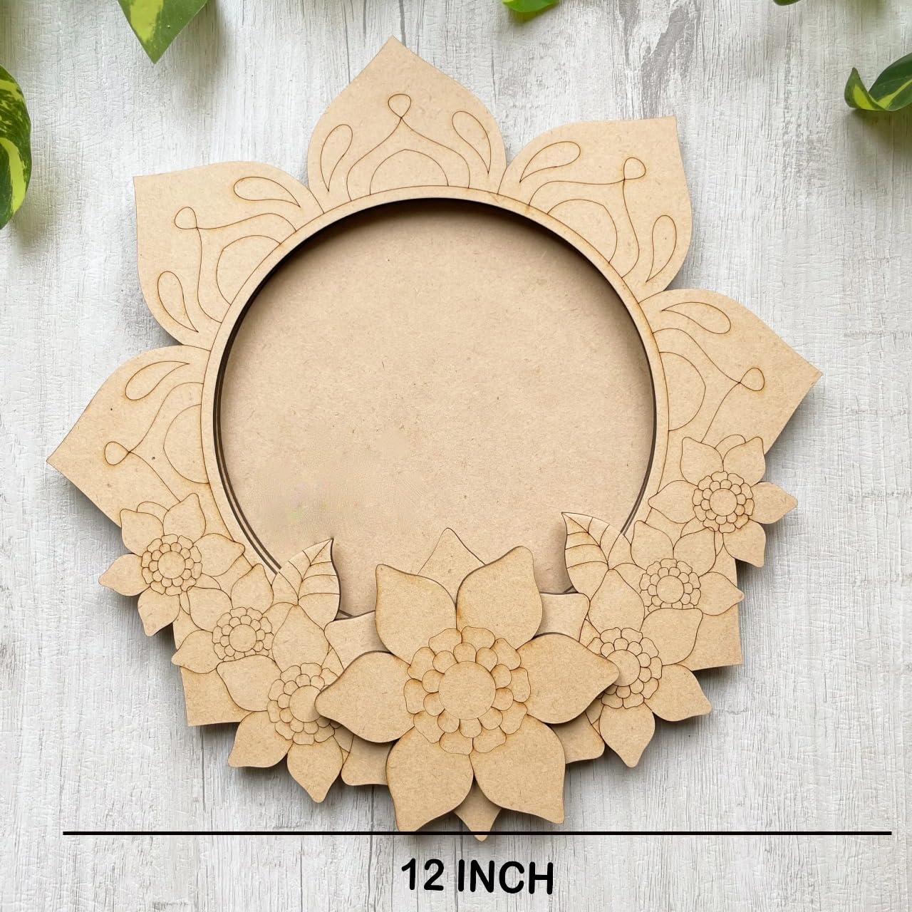 Decorative cardboard wreath with floral patterns on a light wooden surface.