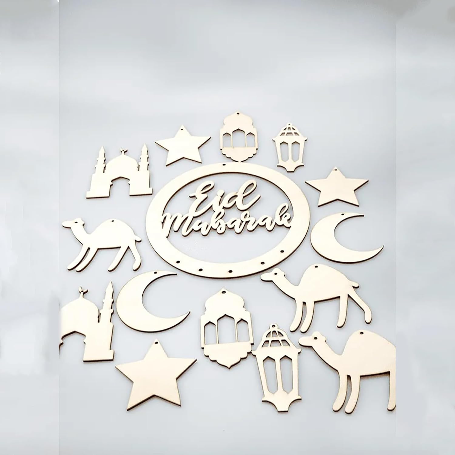 Decorative wall art with 'Eid Mubarak' text and Islamic symbols on a light gray background