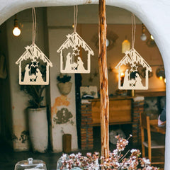 Three wooden nativity scene cutouts hanging against a blurred indoor background.