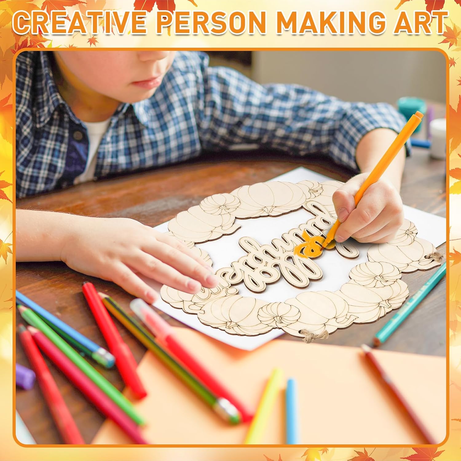 Person making art with wooden letters and colored pencils on a table.
