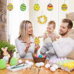 Family of three engaging in Easter egg decorating activity with colorful eggs and supplies on a table.