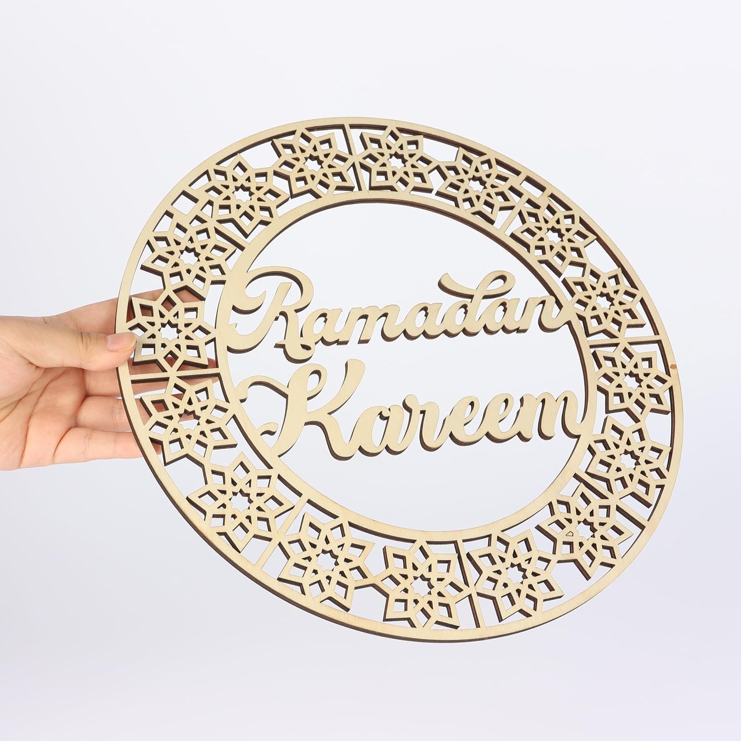 Wooden decorative plate with 'Ramadan Kareem' text on a white background
