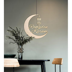 Decorative wall sign with 'Ramadan Kareem' on a gray wall above a table with a vase and plants.