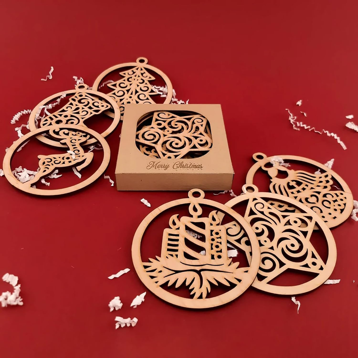 Wooden Christmas ornaments with a 'Merry Christmas' box on a red background