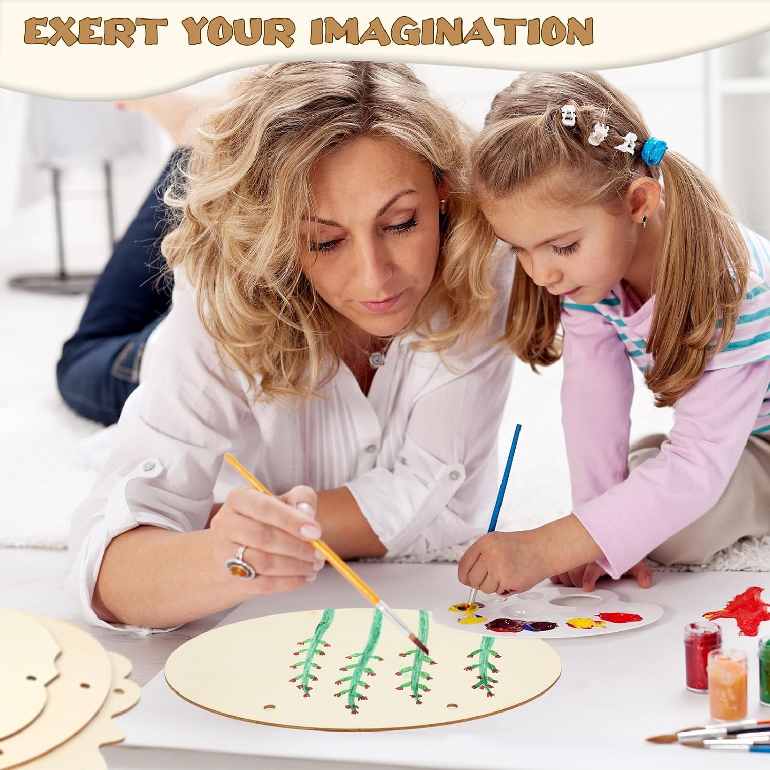 Woman and young girl painting on a wooden board with the text 'Exert Your Imagination' above them.