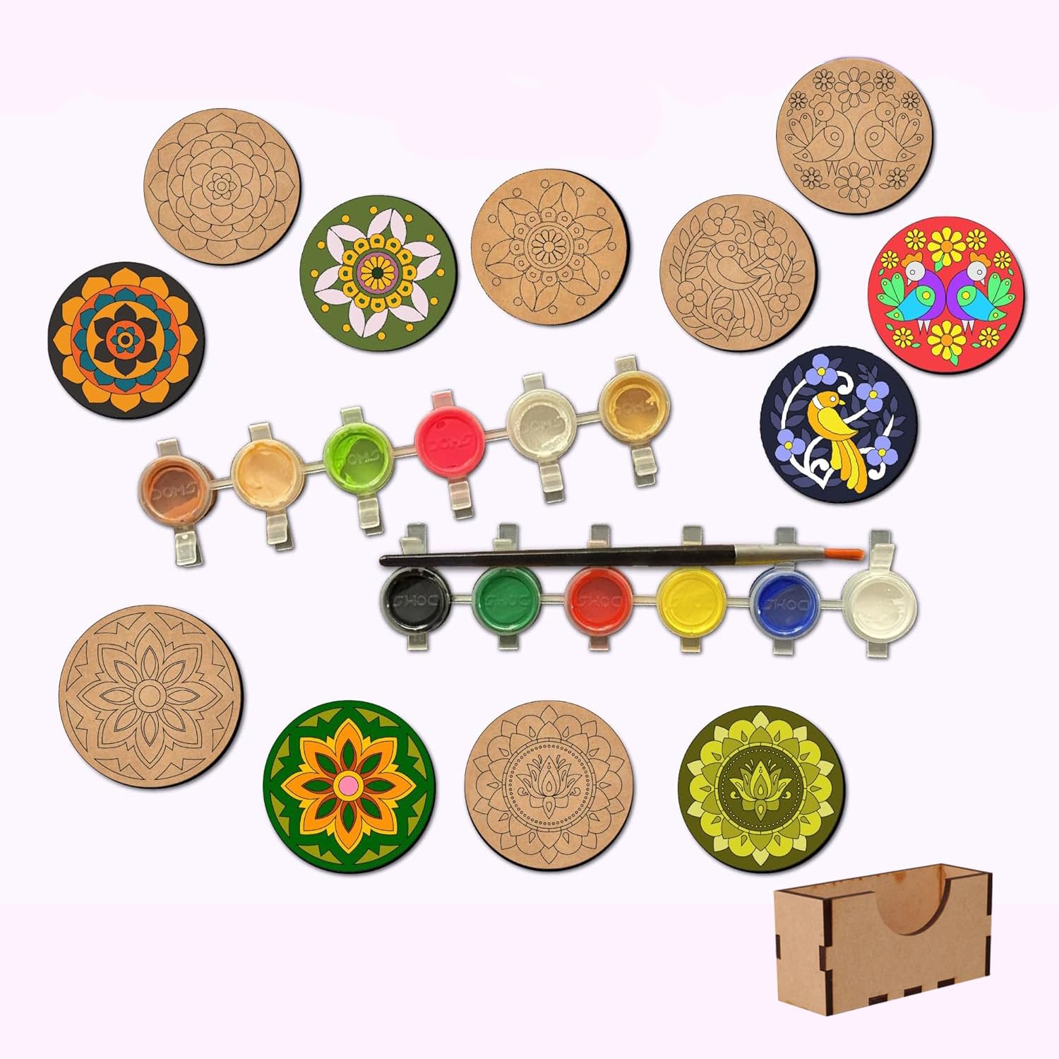 Set of mandala coasters with paint bottles and a brush on a white background