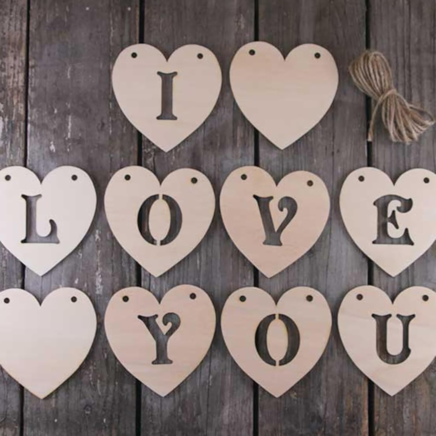 Wooden heart-shaped letters spelling 'I LOVE YOU' on a wooden background