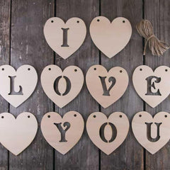 Wooden heart-shaped letters spelling 'I LOVE YOU' on a wooden background
