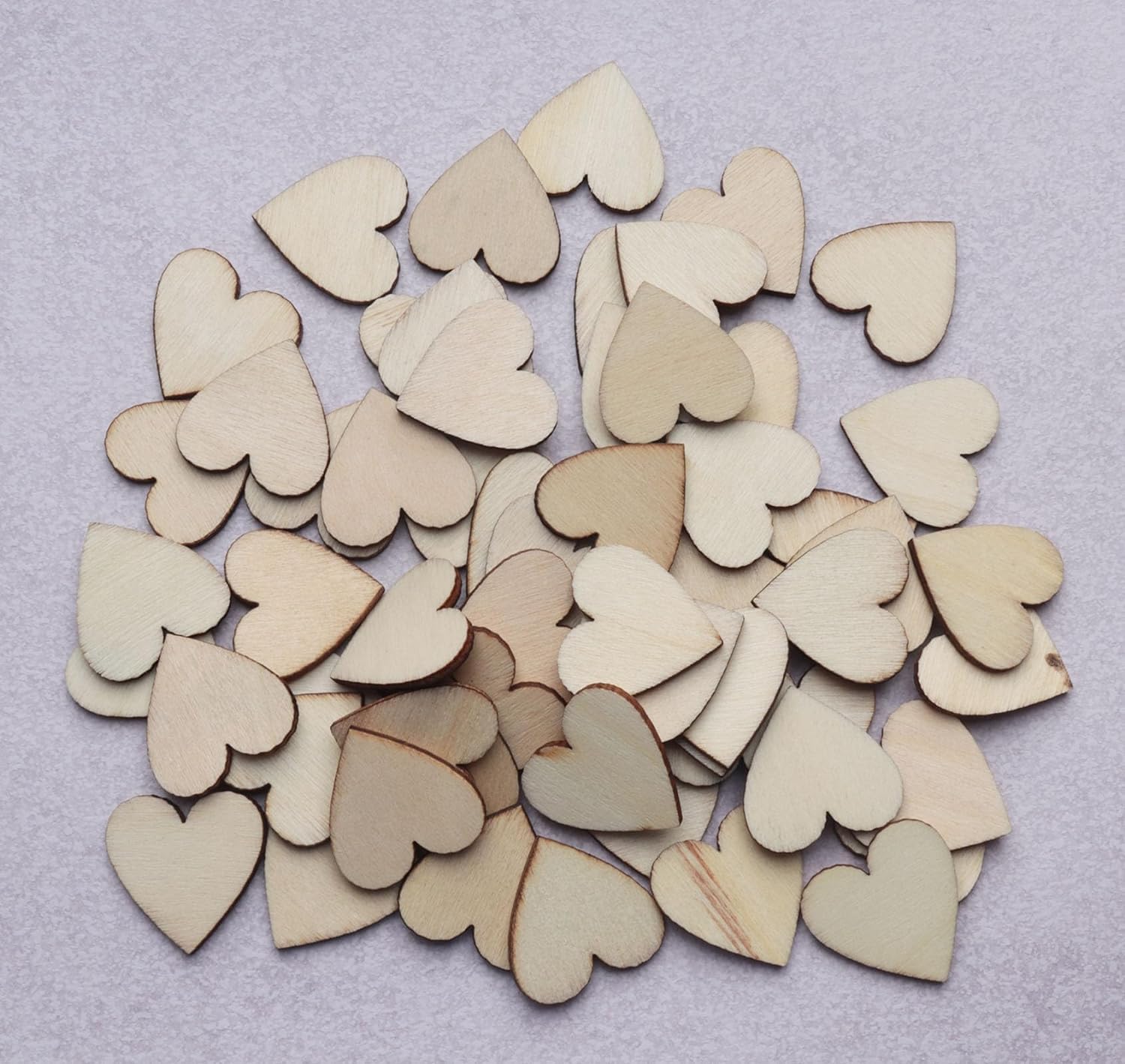 Collection of wooden heart shapes on a light gray background