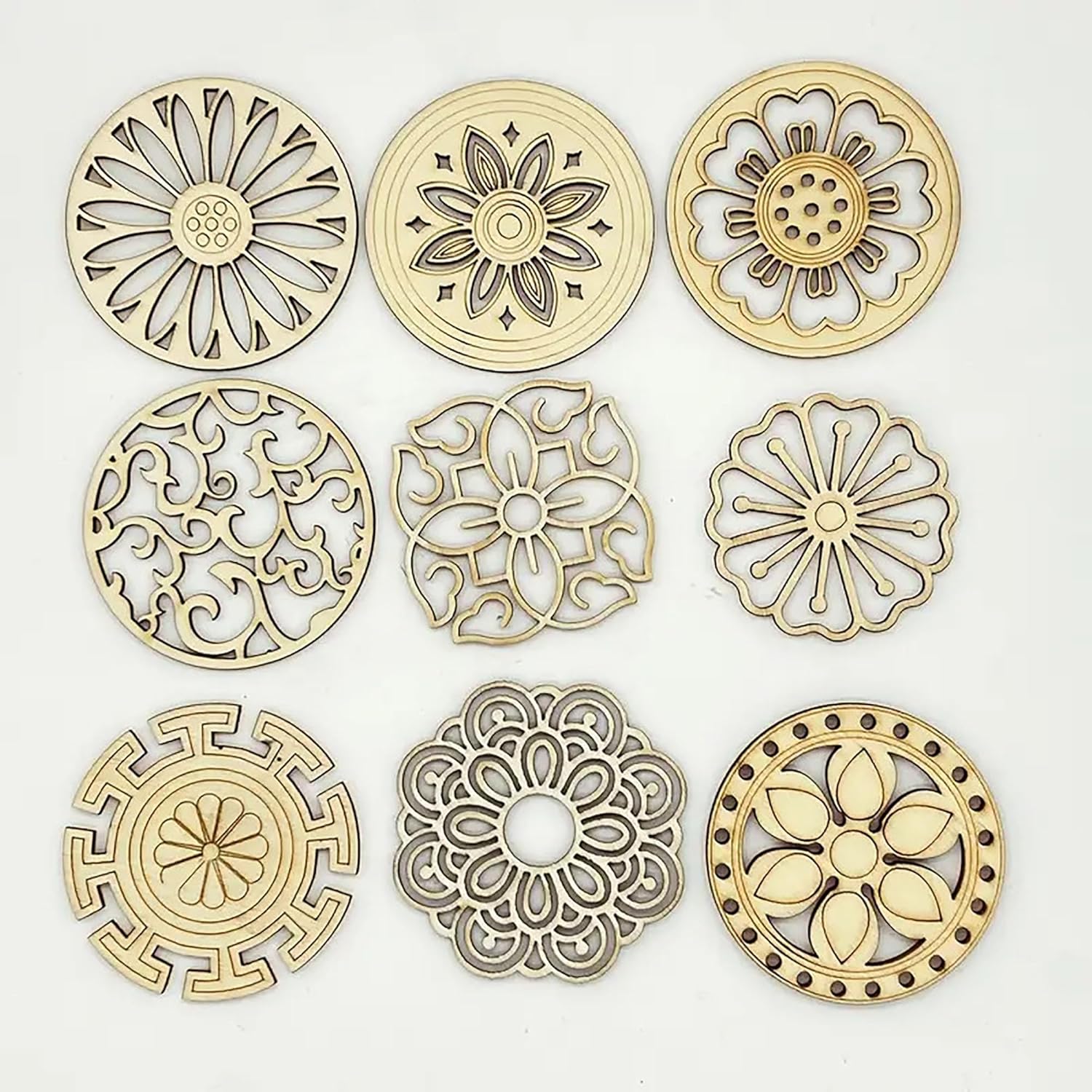 Set of gold decorative circular metal pieces with intricate patterns on a white background