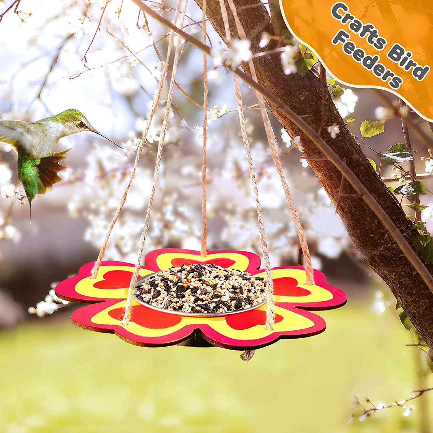 Colorful bird feeder hanging from a branch with a blurred natural background