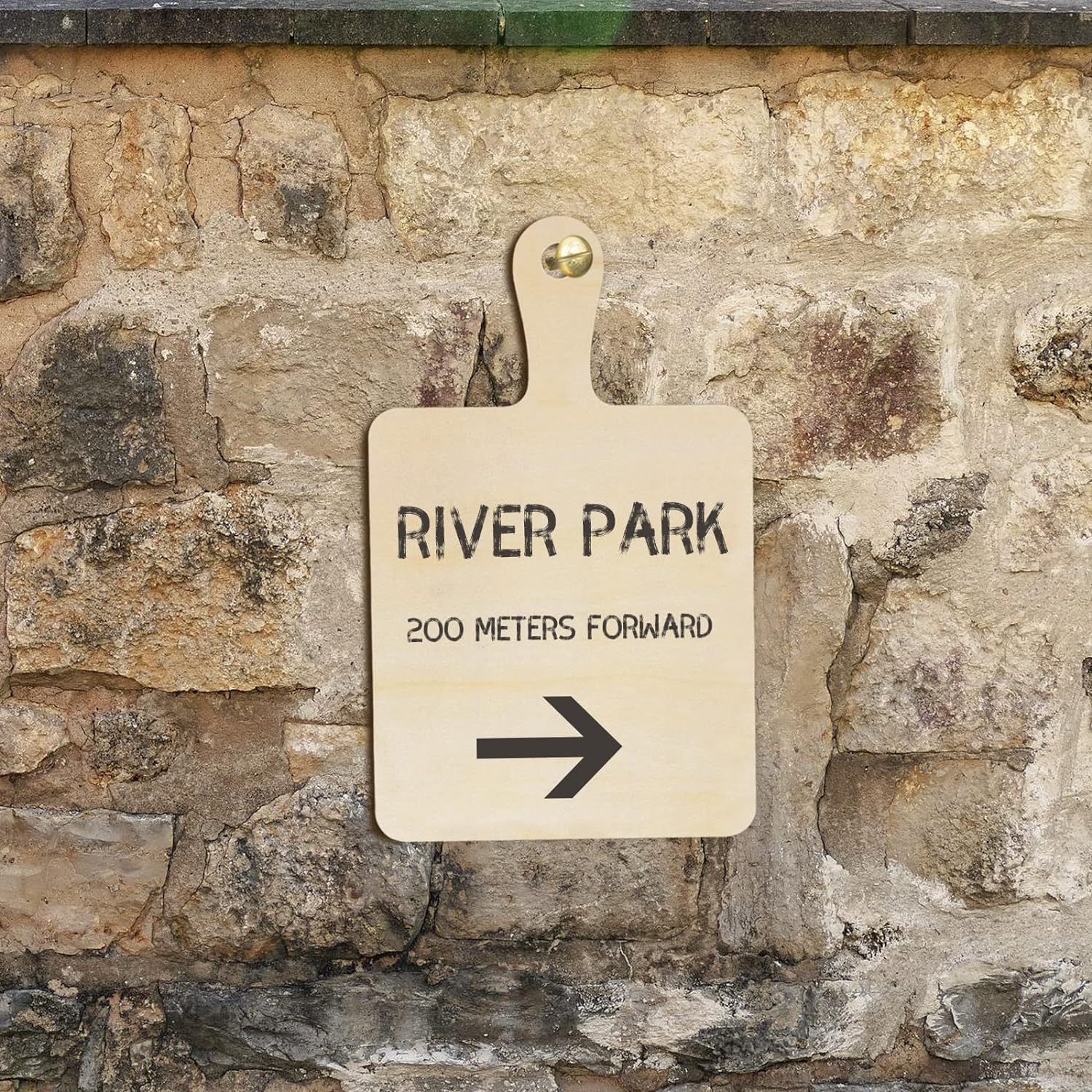 Directional sign pointing to River Park on a stone wall