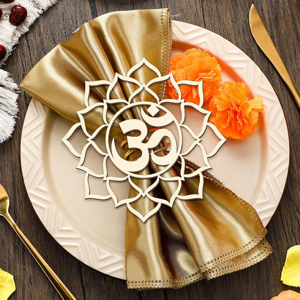 Decorative plate with gold napkin and 'Om' symbol, set on a wooden table.