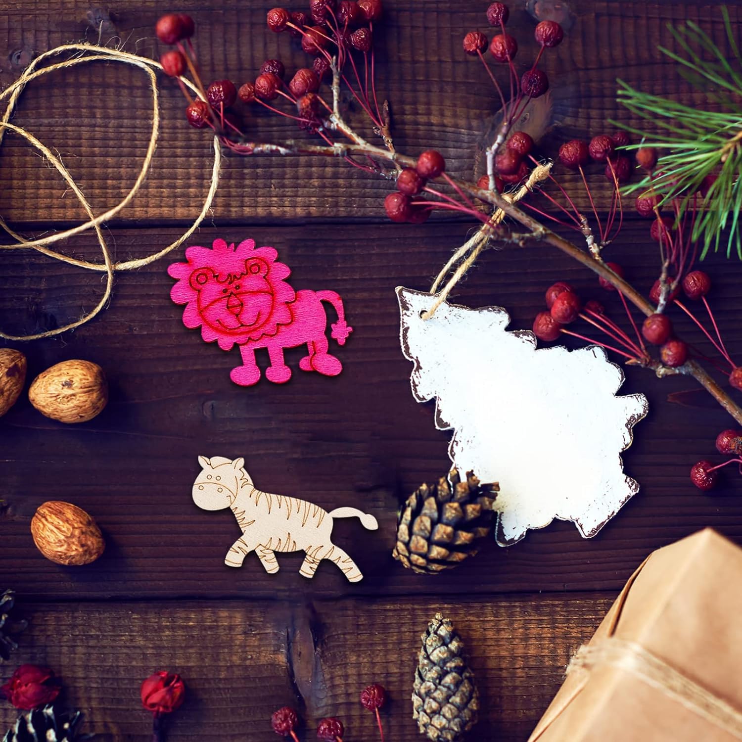 Decorative animal-shaped ornaments on a wooden surface with berries and pine cones.