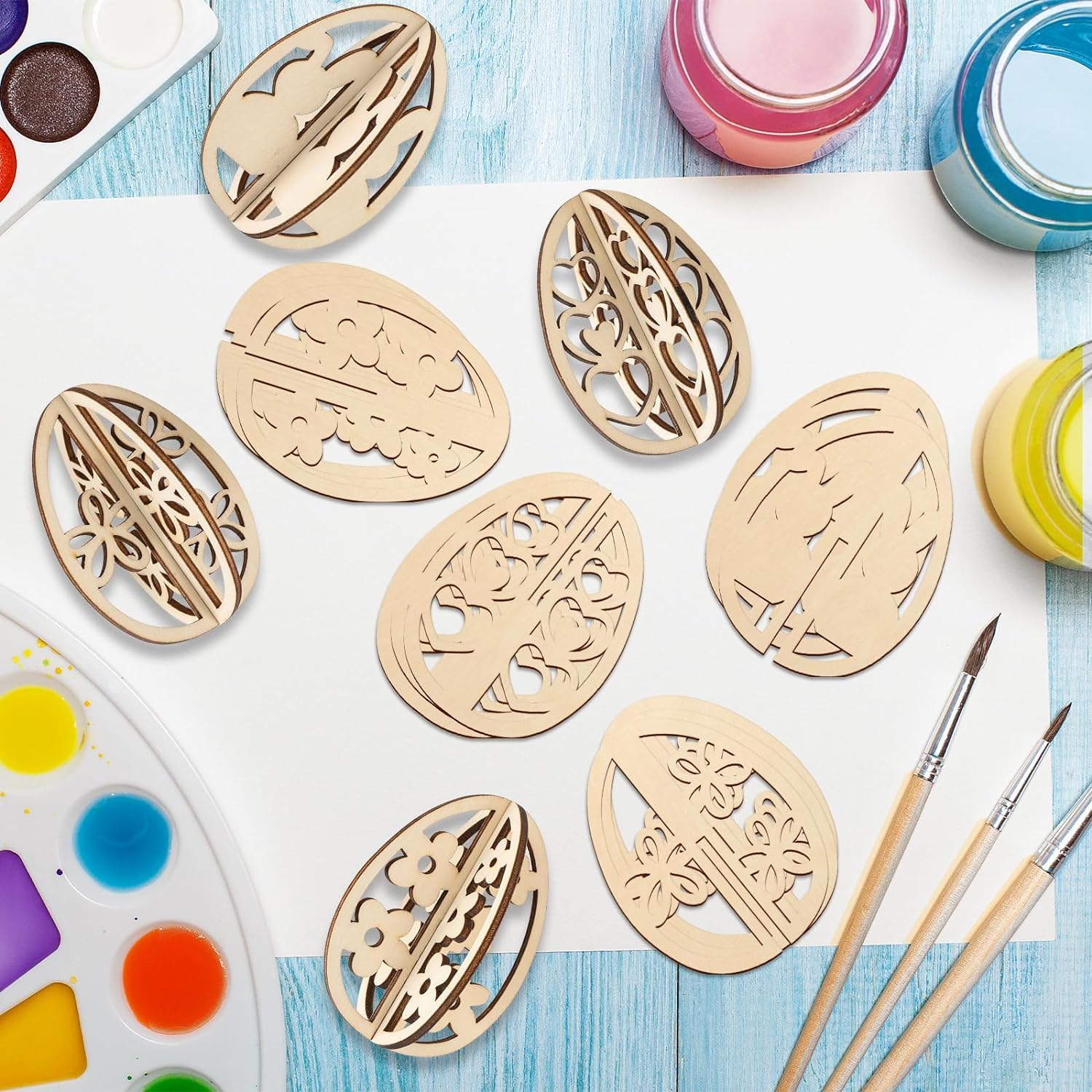 Wooden stencils with intricate designs on a table with paint and brushes