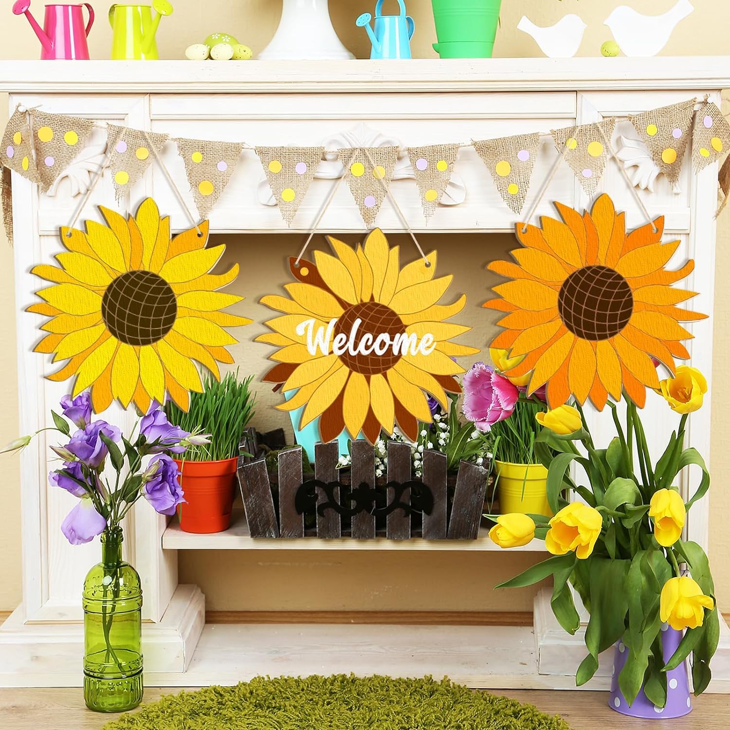 Decorative sunflower-themed 'Welcome' sign with flowers and plants on a shelf.