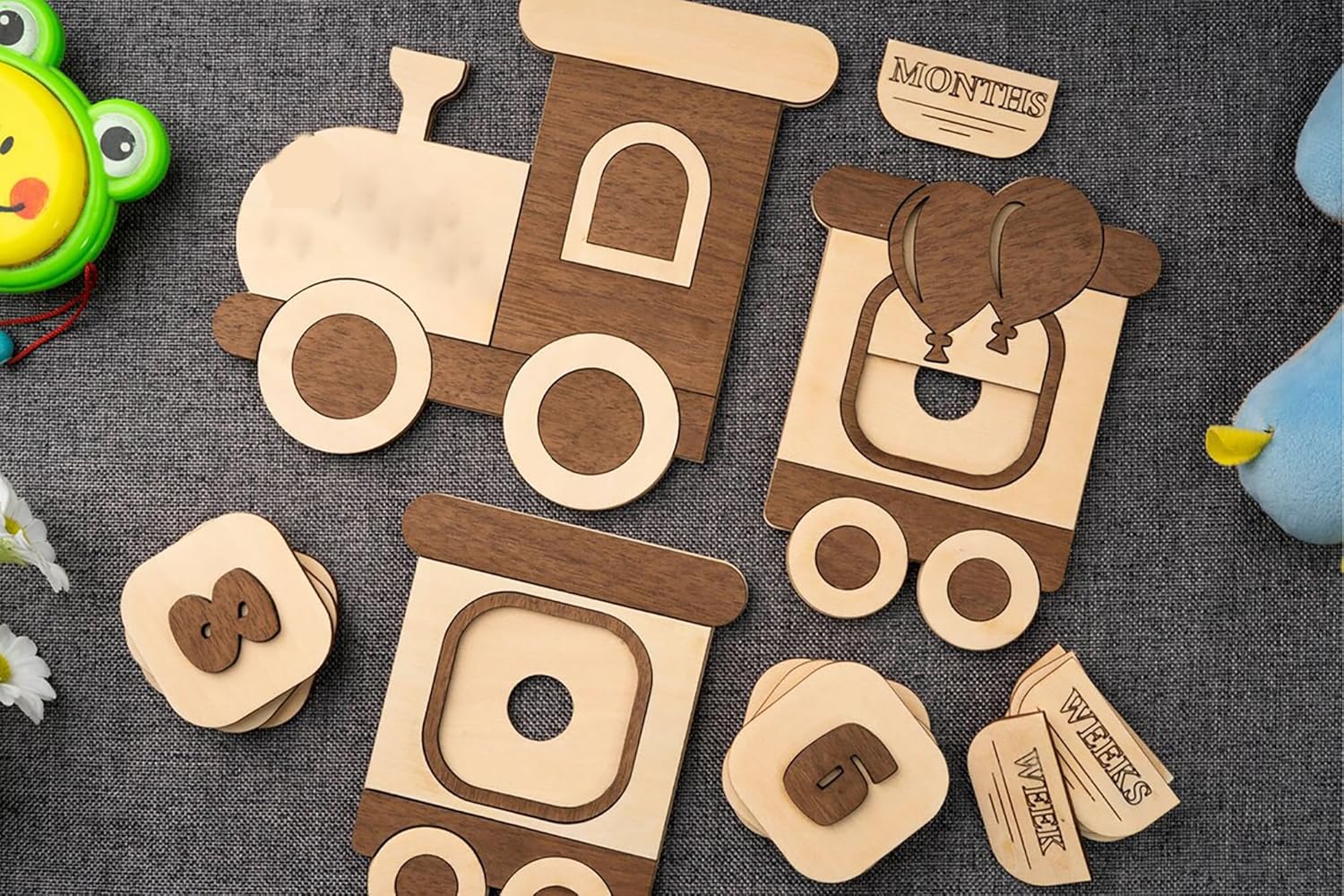 Wooden toy train pieces on a textured surface