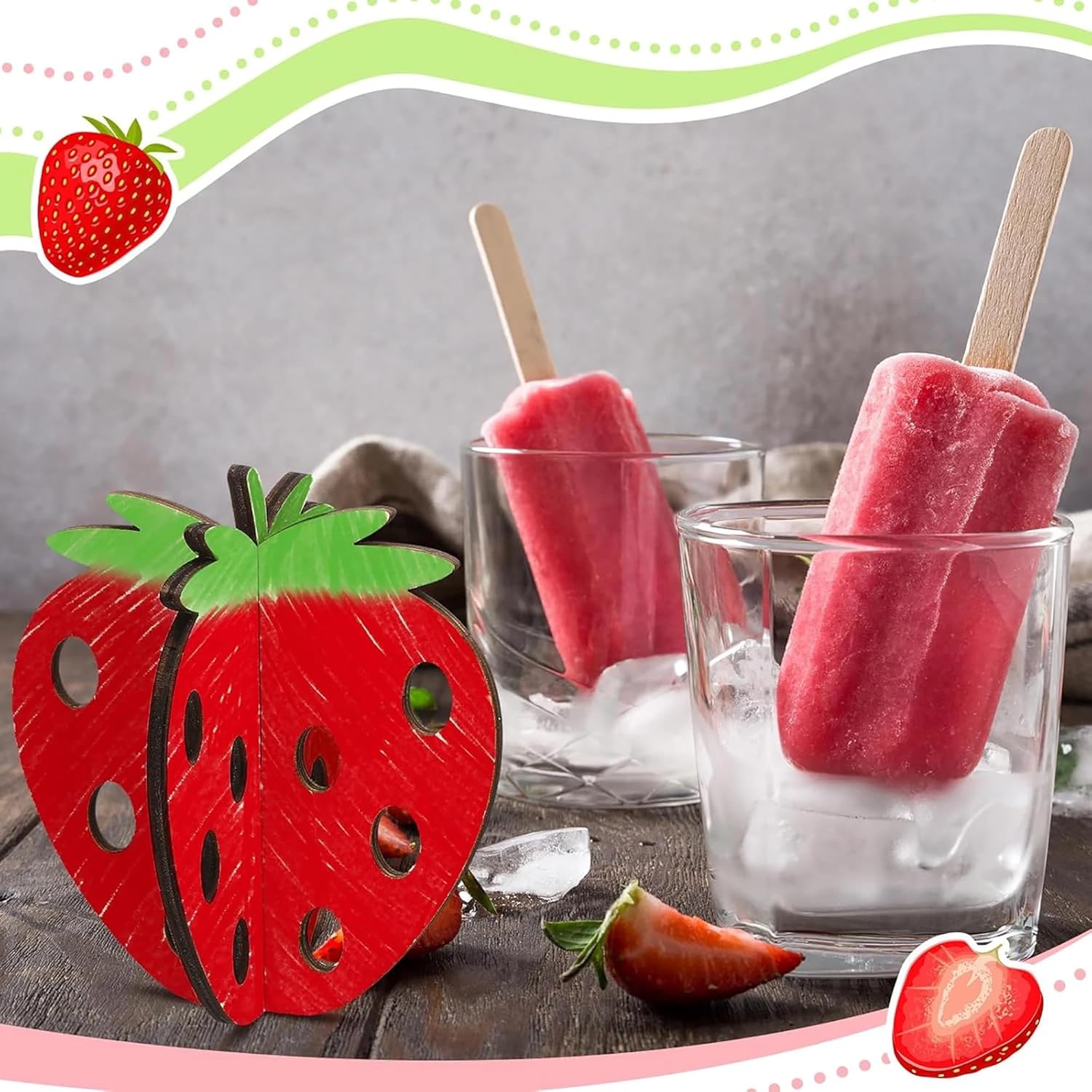 Strawberry-shaped popsicle mold with red strawberry popsicles in glasses filled with ice.