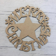 Wooden Christmas star decoration with 'Merry Christmas' cutout letters on a light wooden background