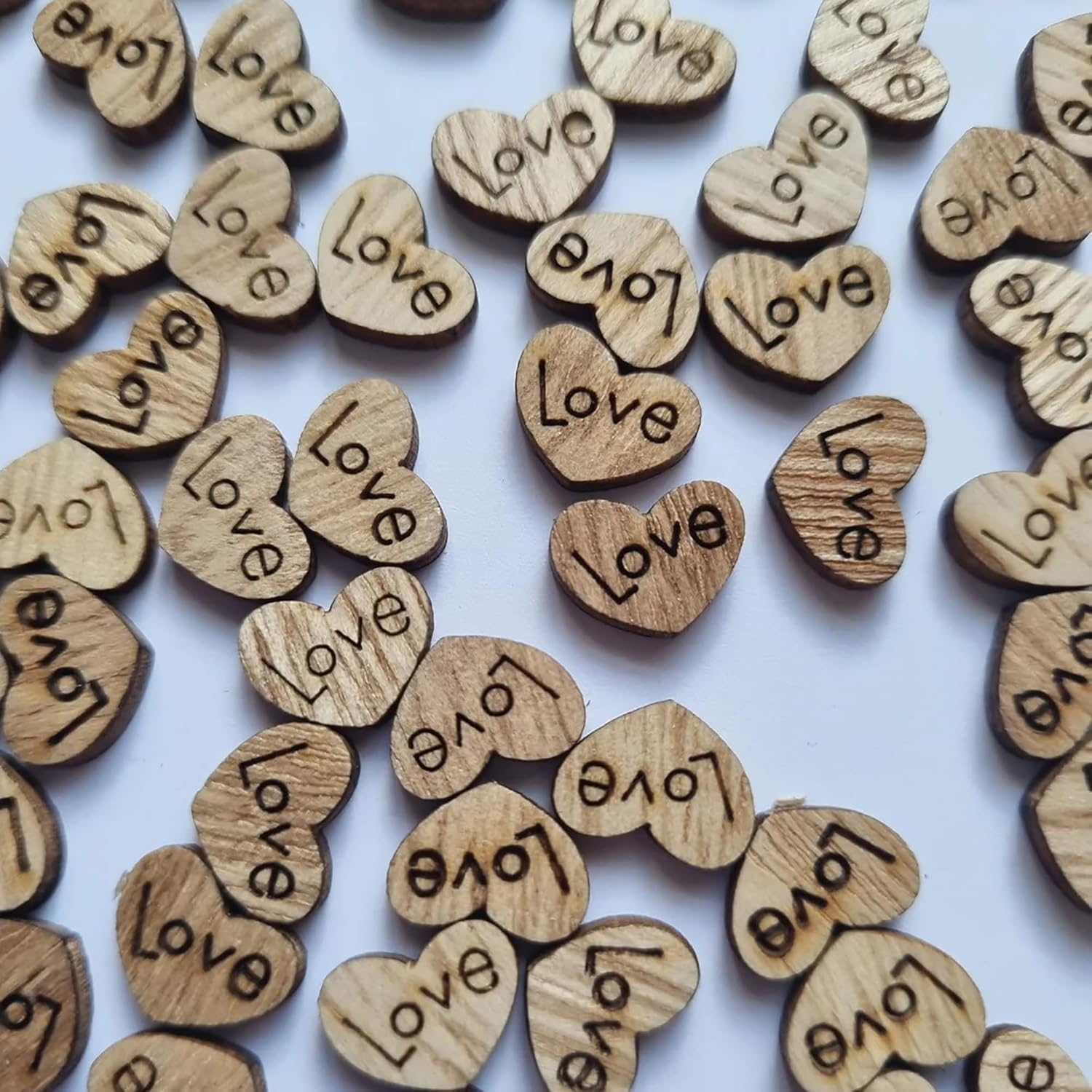 Wooden hearts with 'Love' engraved on a white background