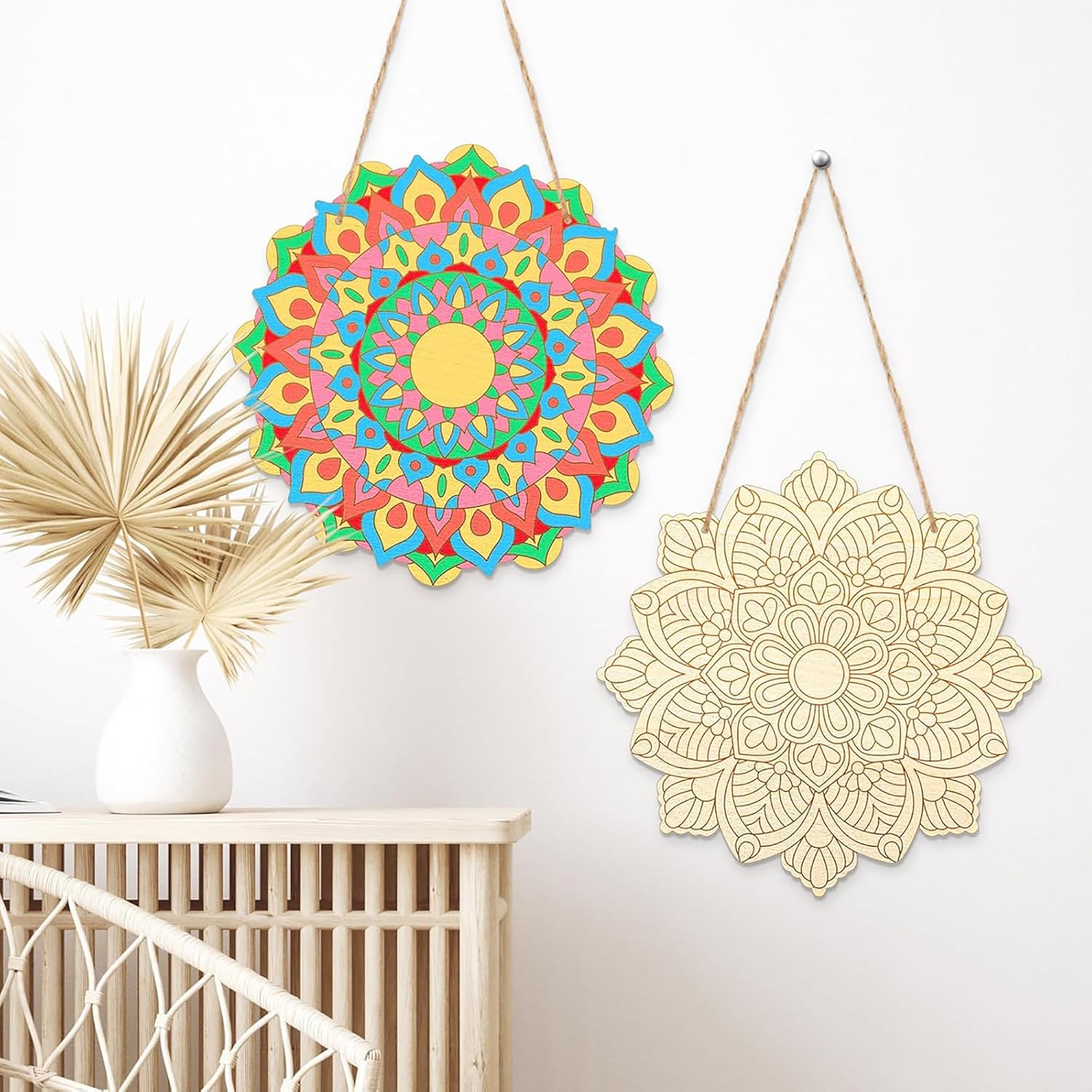 Colorful and gold mandala wall art pieces hanging on a white wall.