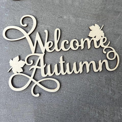 Decorative sign with 'Welcome Autumn' text on a gray background