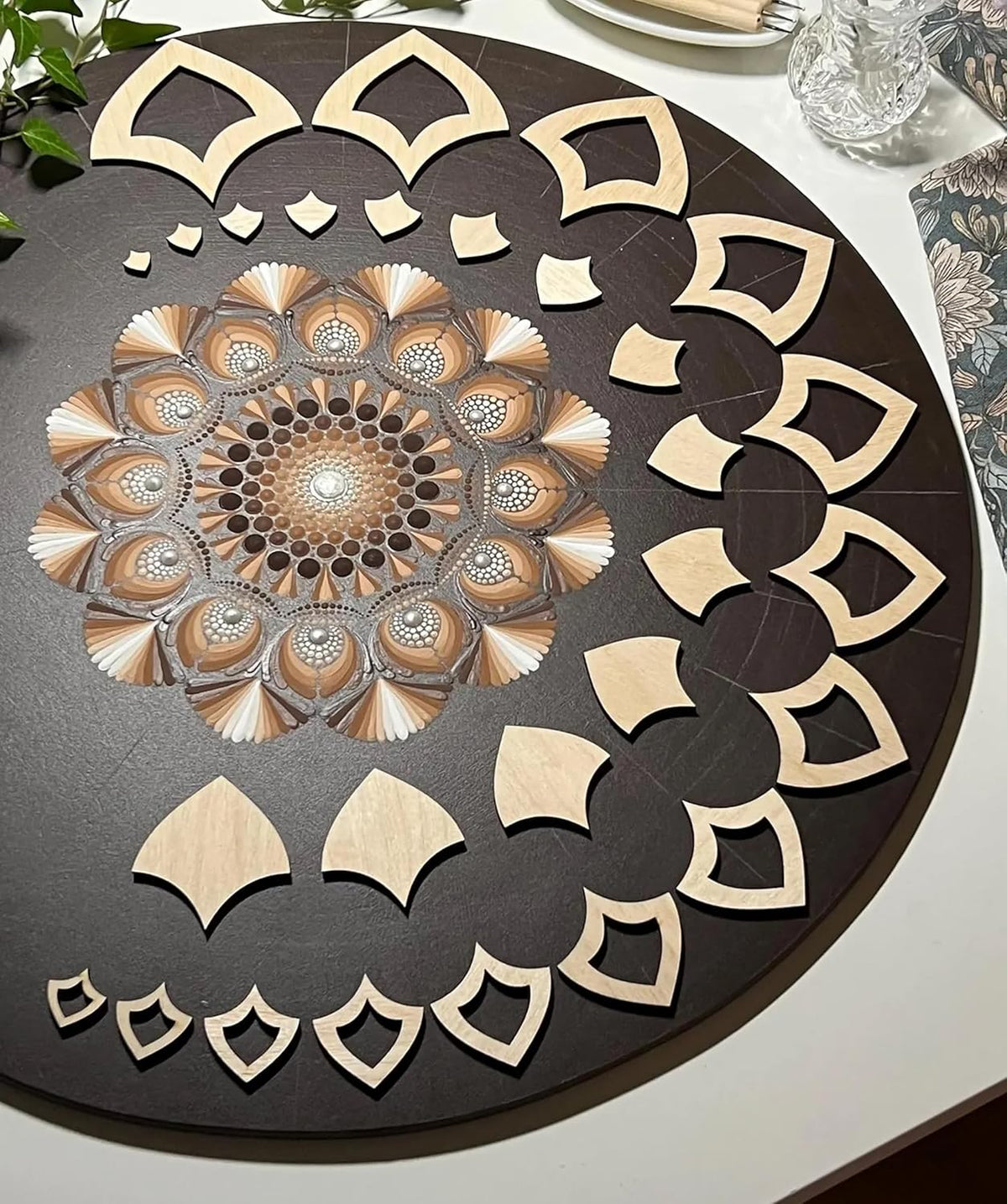 Decorative wooden cutout with intricate patterns on a dark surface