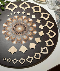Decorative wooden cutout with intricate patterns on a dark surface