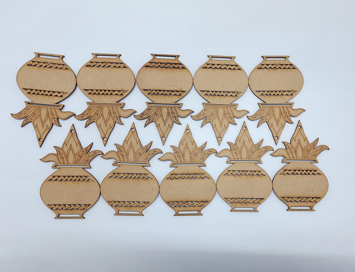 Set of laser cut decorative elements on a light gray background