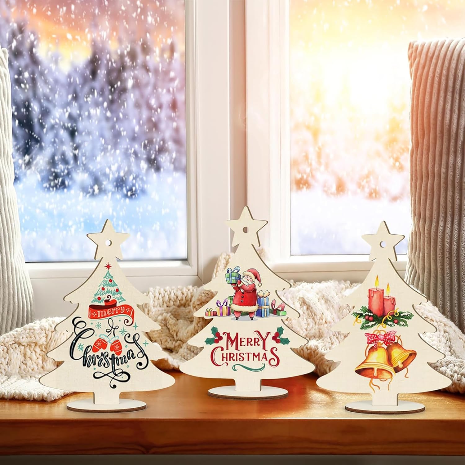 Decorative Christmas trees with festive designs on a wooden surface.