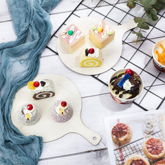 Assorted desserts including cakes and a drink on a white surface with a blue cloth.