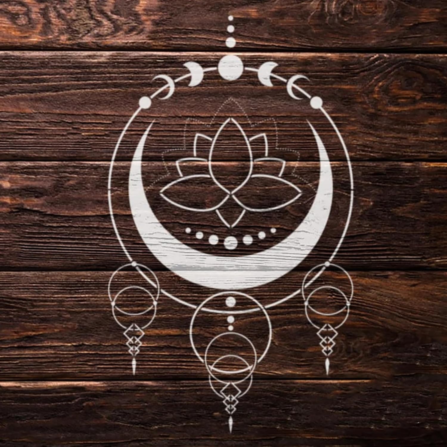Decorative white symbol with lotus flower and crescent moon on a wooden background