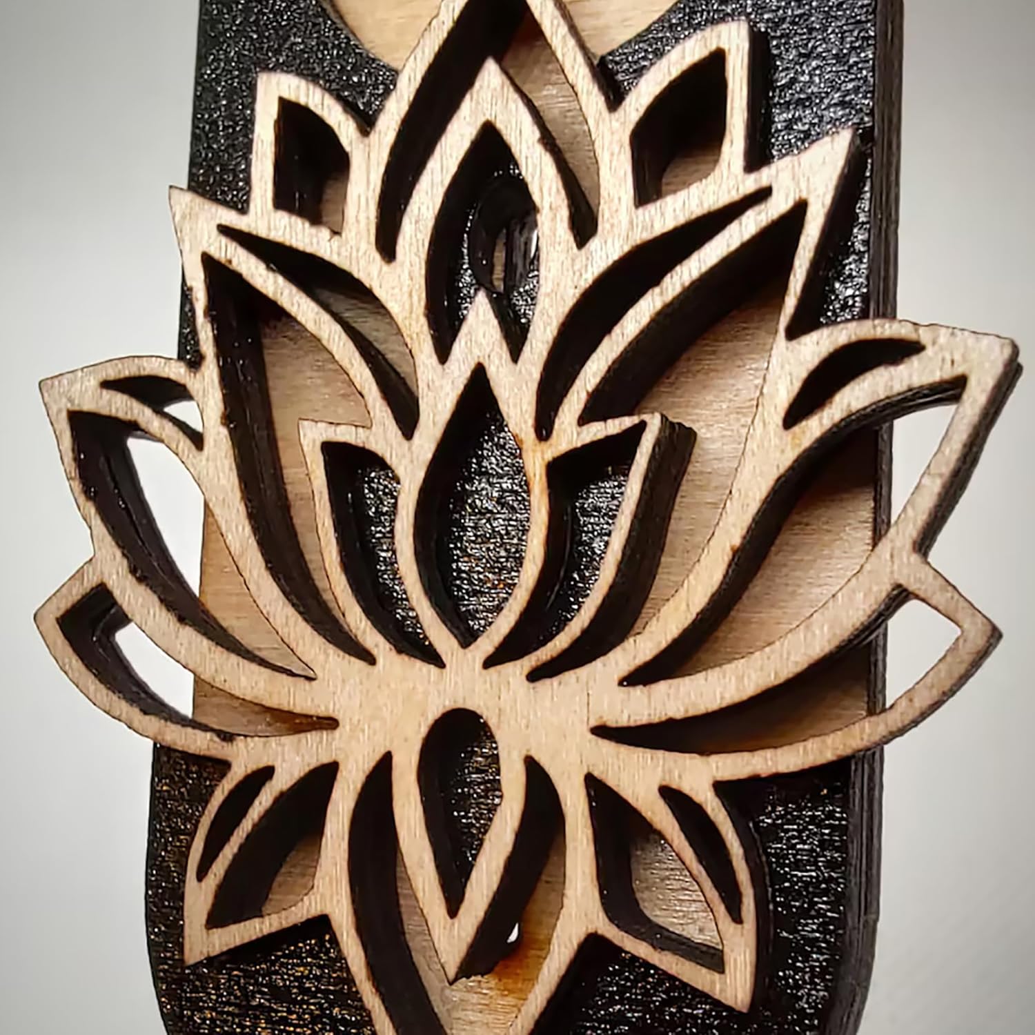 Wooden lotus flower wall art on a black background