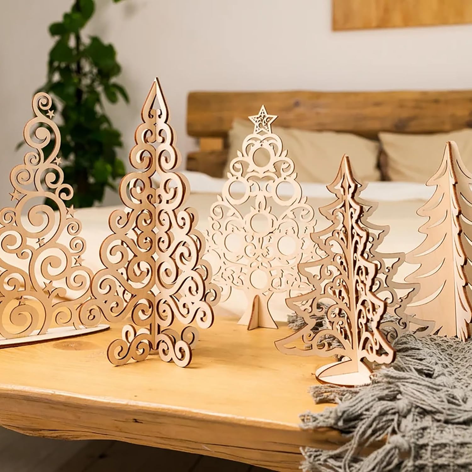 Wooden Christmas tree decorations on a wooden surface with a blurred background