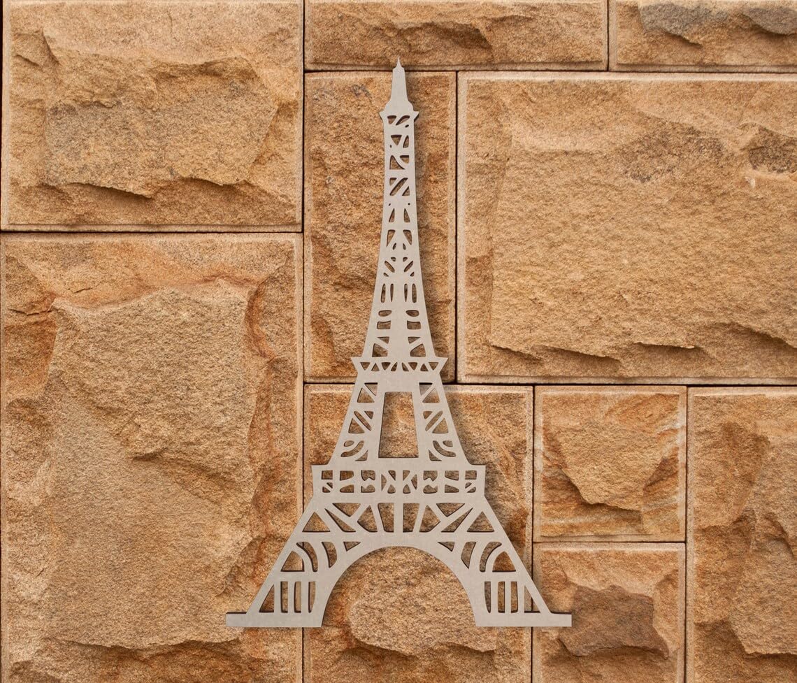 Metallic Eiffel Tower decoration on a stone wall