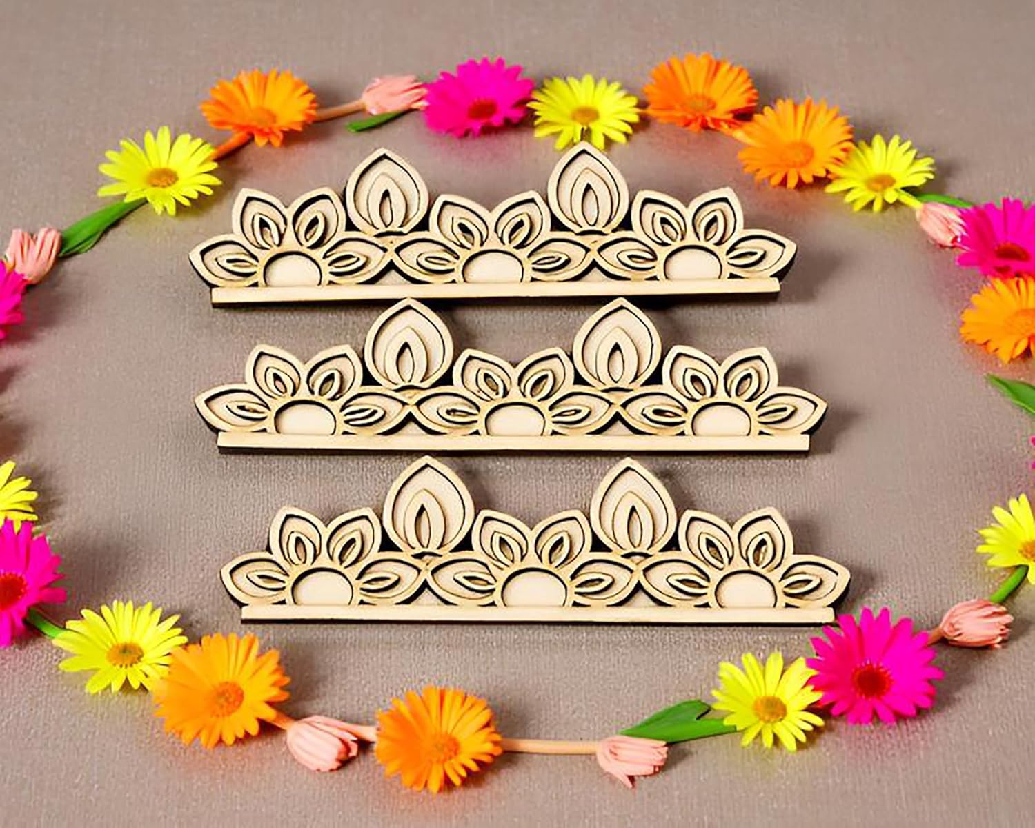 Wooden tiara cutouts with colorful flowers on a gray background