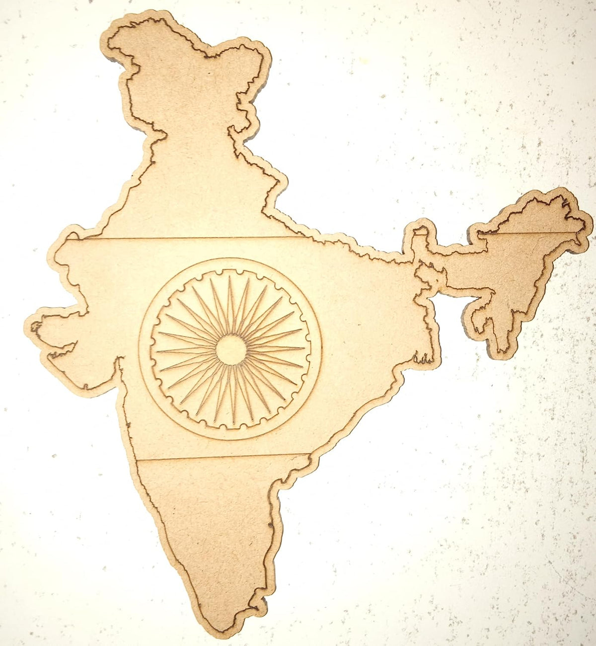 Wooden cutout of a map of India with the Ashoka Chakra in the center on a light background