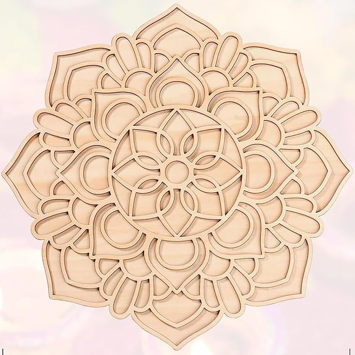 Decorative wooden mandala on a light pink background