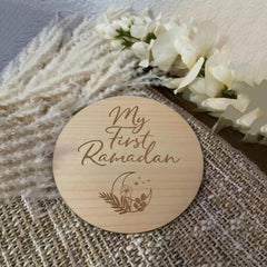 Wooden coaster with 'My First Ramadan' engraving on a textured surface with flowers.