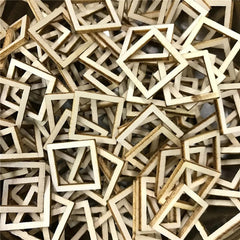 Pile of small wooden square frames on a dark surface
