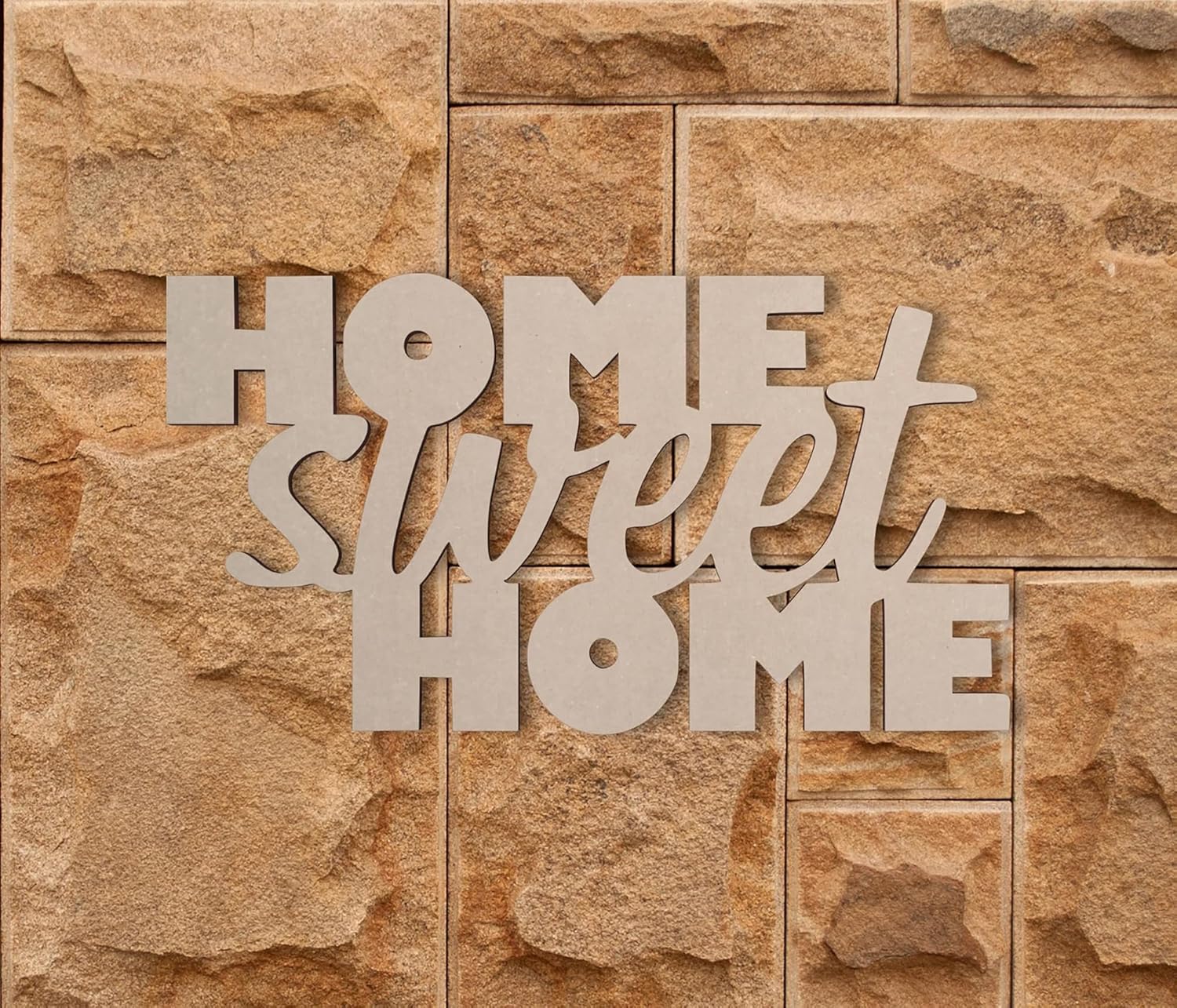 Decorative sign with 'Home Sweet Home' on a stone wall
