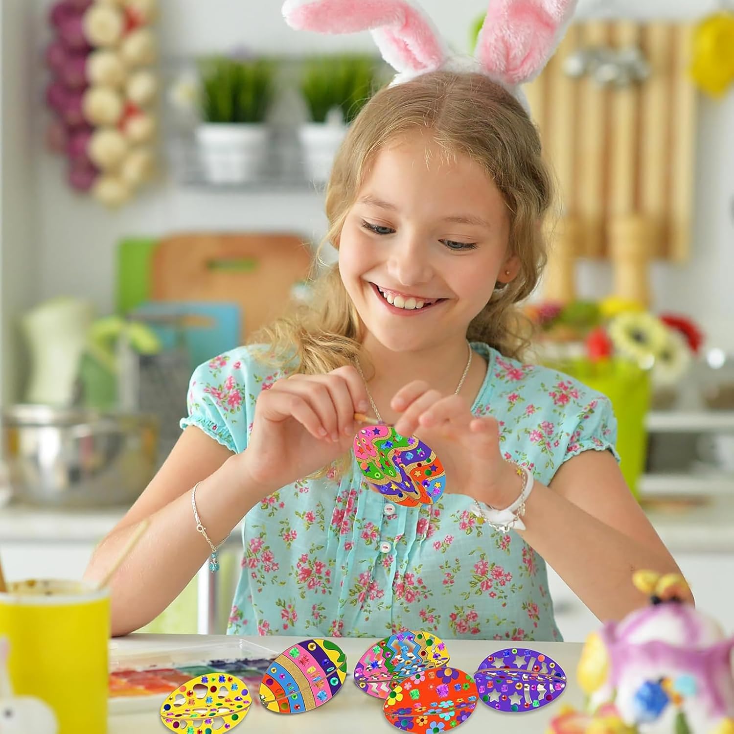 Young girl wearing bunny ears, making colorful crafts in a kitchen setting