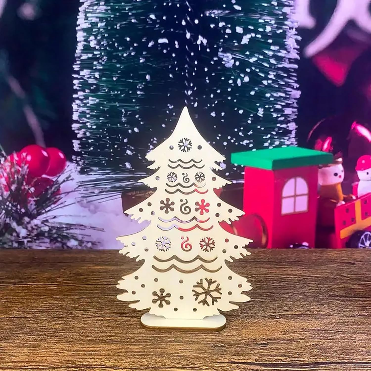 Wooden Christmas tree decoration on a wooden surface with a blurred festive background.