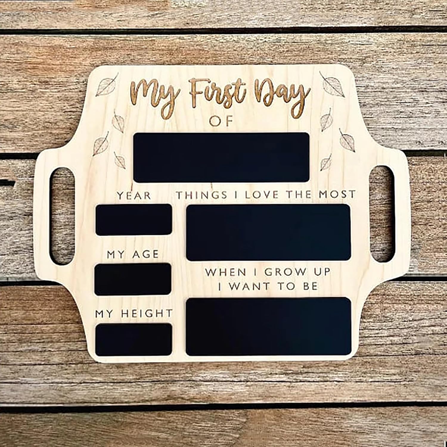 Wooden plaque with engraved text for 'My First Day' on a wooden background